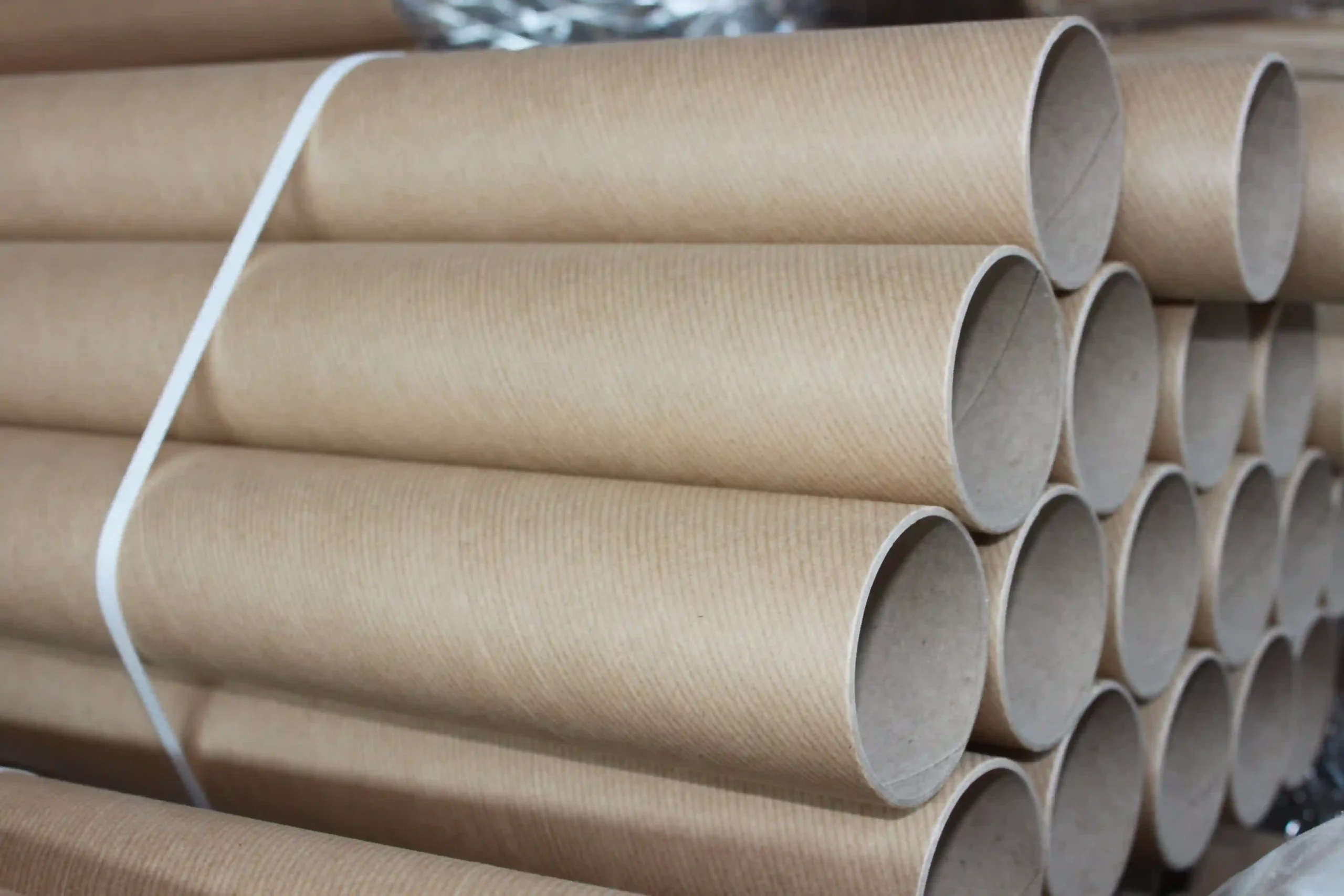 cardboard tubes piled together in a group